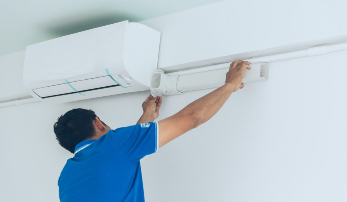 Pelican Heating and Air technician servicing a residential air conditioning unit in Bellevue, WA