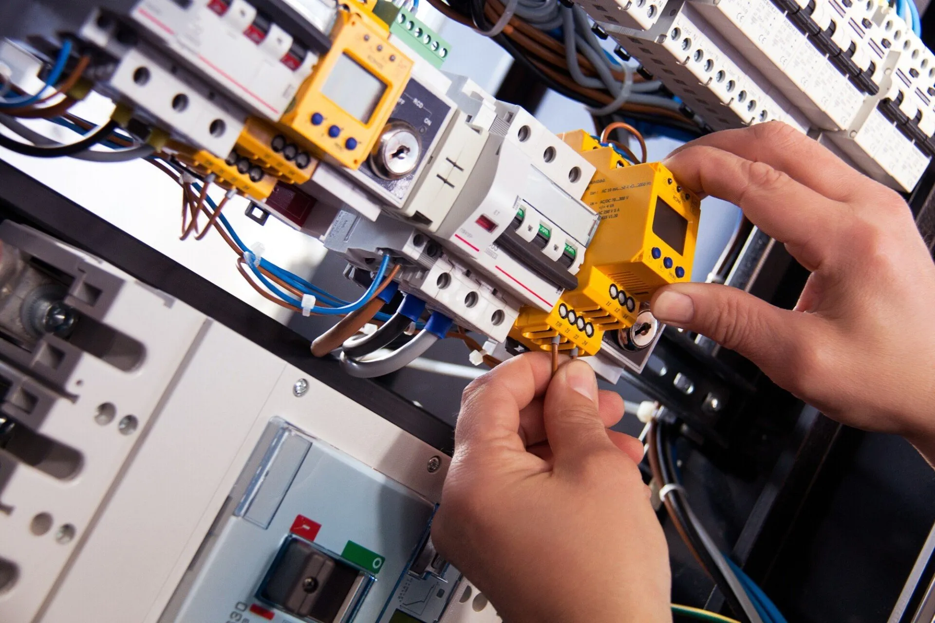 Technician from Pelican Heating & Air servicing air conditioner in Newcastle backyard