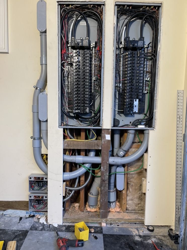 Technician from Pelican Heating & Air servicing air conditioner in Newcastle backyard