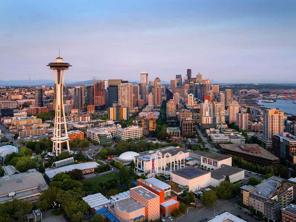 Pelican Heating & Air technician working on rooftop AC unit in downtown Seattle