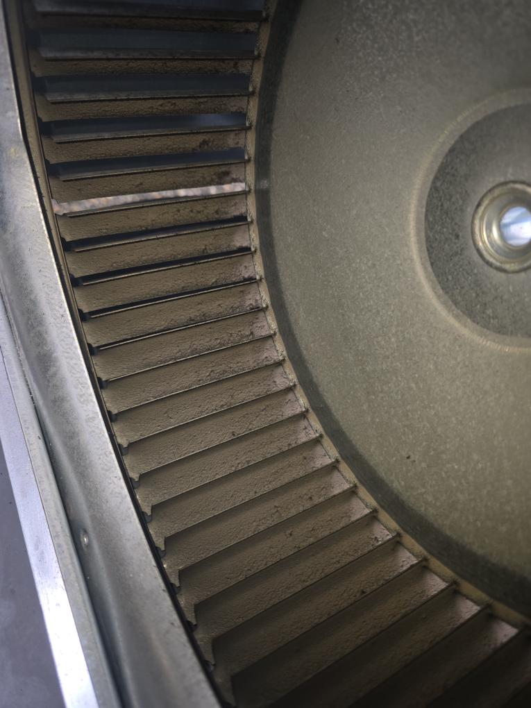 Pelican Heating & Air technician performing premium furnace cleaning in Redmond, WA home, ensuring efficiency and safety