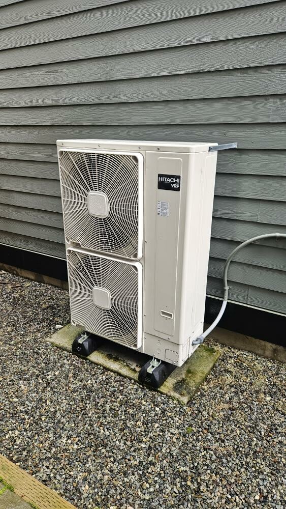 Pelican Heating and Air technician servicing a residential air conditioning unit in Bellevue, WA