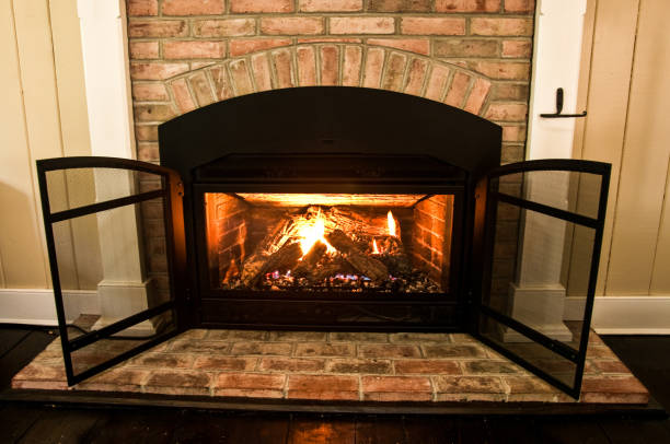 Specialist performing Gas Fireplace Service beside a vented fireplace in a Mercer Island, WA family room