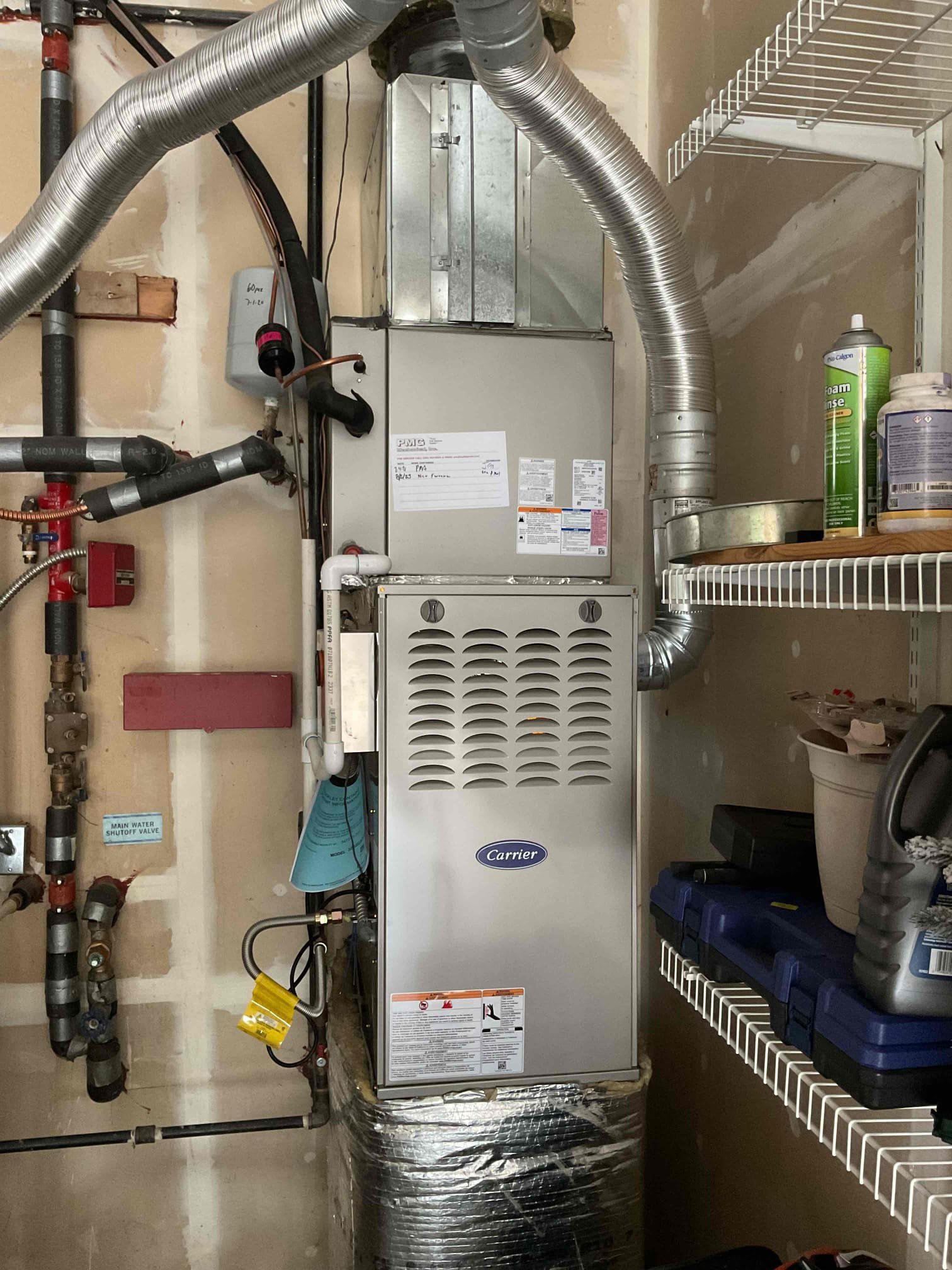 Technician performing Boiler Service in a Seattle, WA basement while testing pressure and circulation controls