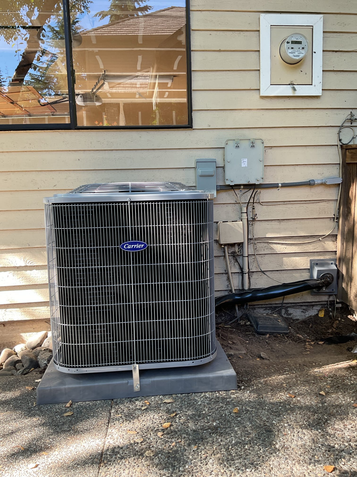 Pelican Heating and Air technician servicing a residential air conditioning unit in Bellevue, WA