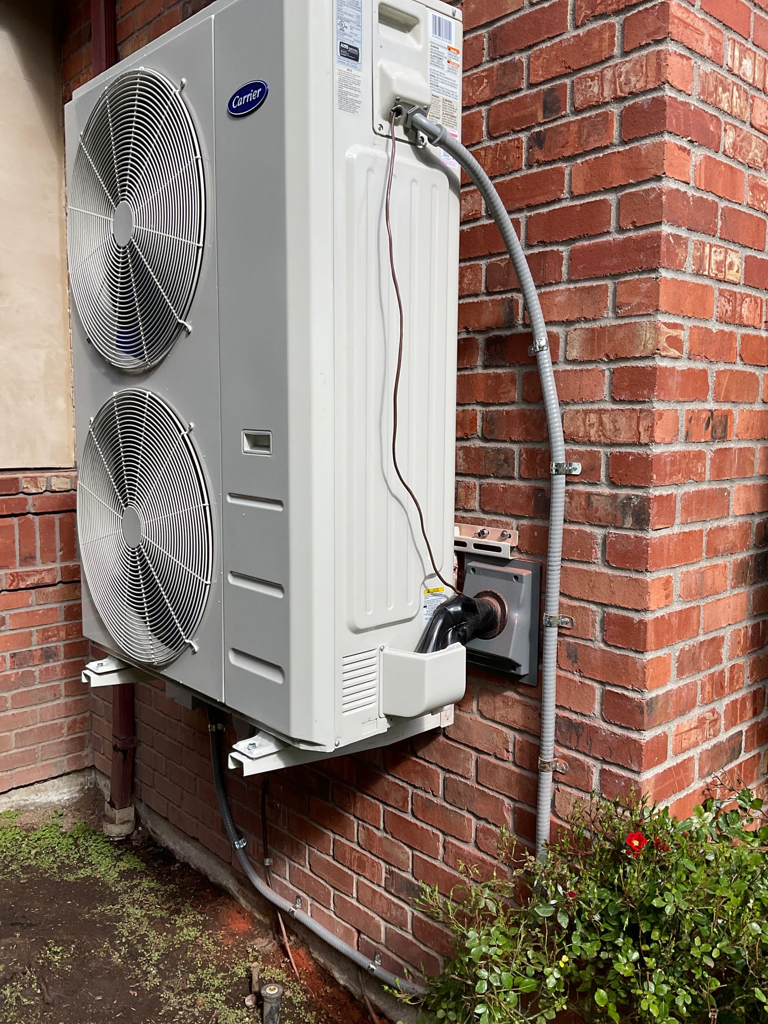 Pelican Heating and Air technician servicing a residential air conditioning unit in Bellevue, WA