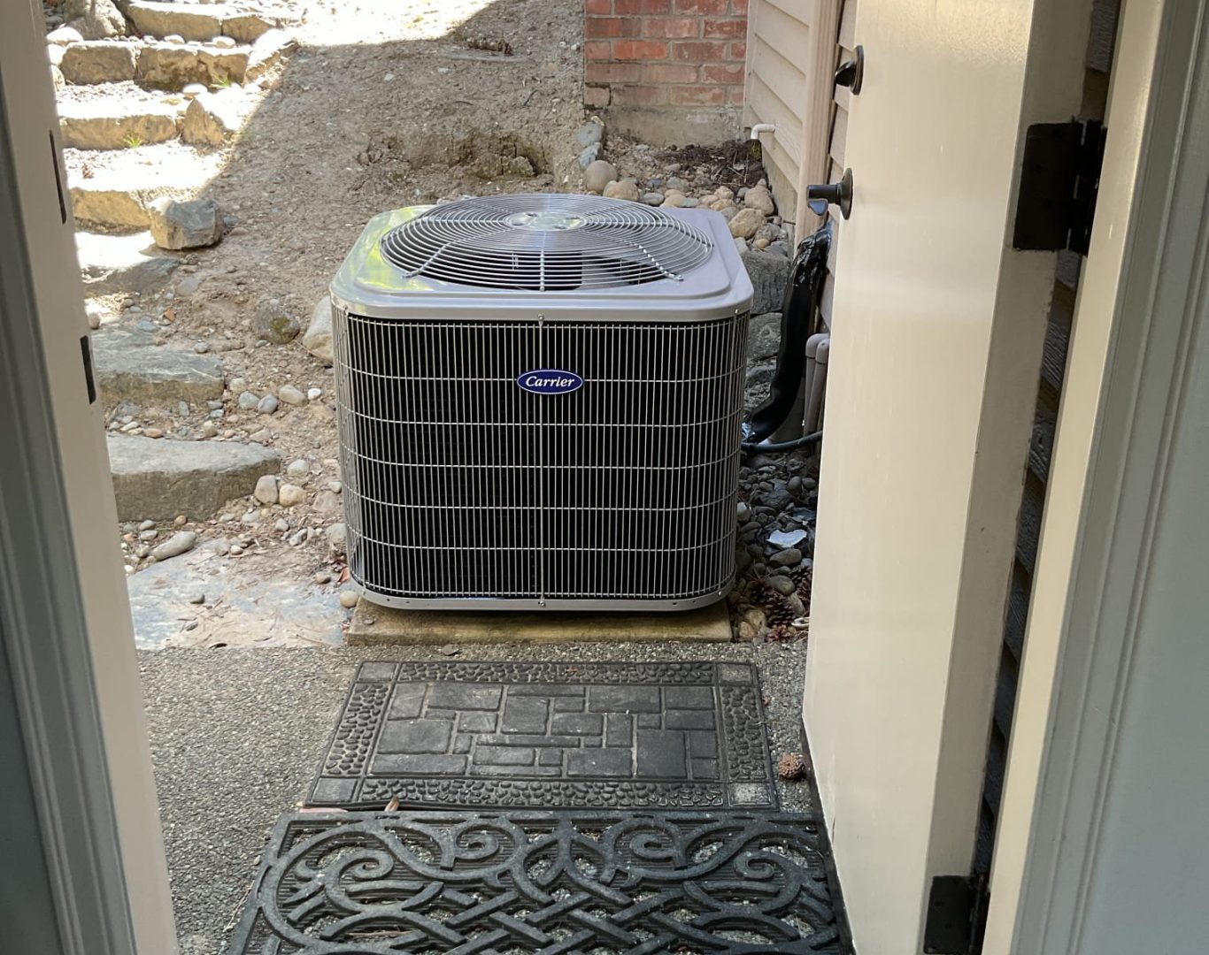 Pelican Heating and Air technician servicing a residential air conditioning unit in Bellevue, WA
