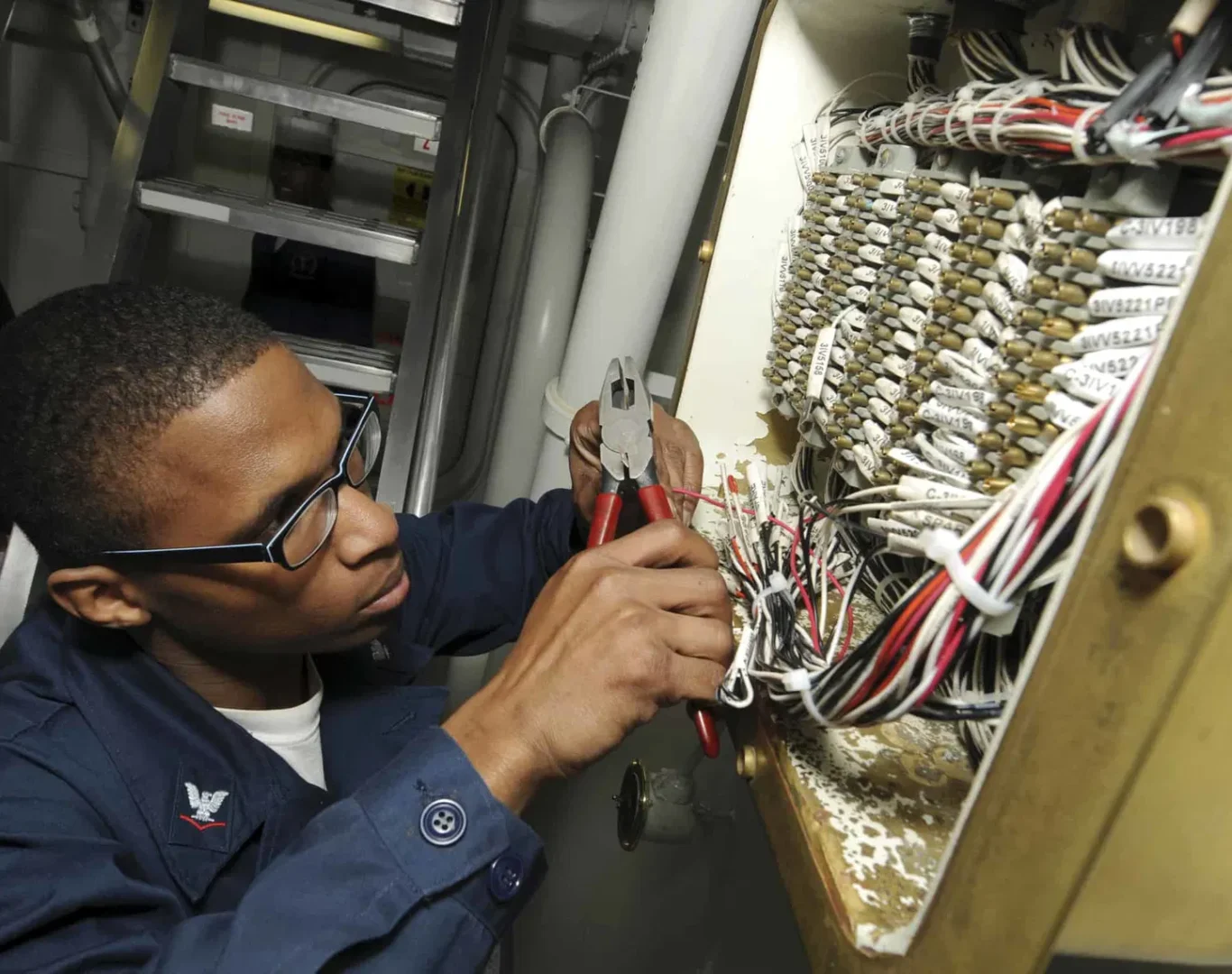 Technician from Pelican Heating & Air servicing air conditioner in Newcastle backyard