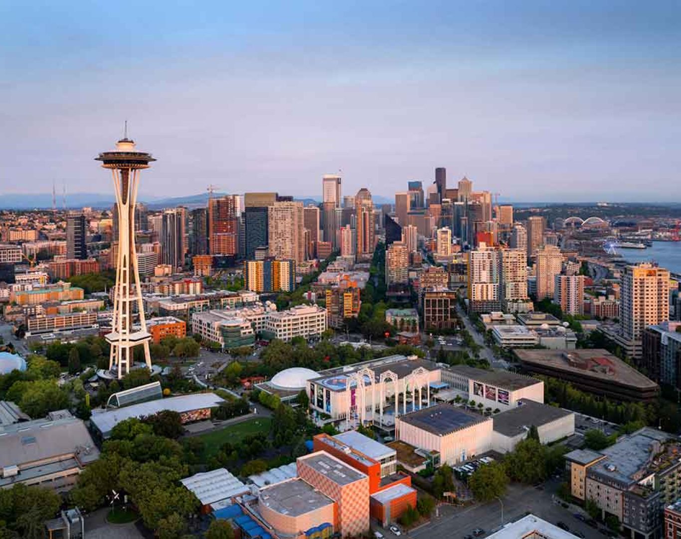 Pelican Heating & Air technician working on rooftop AC unit in downtown Seattle