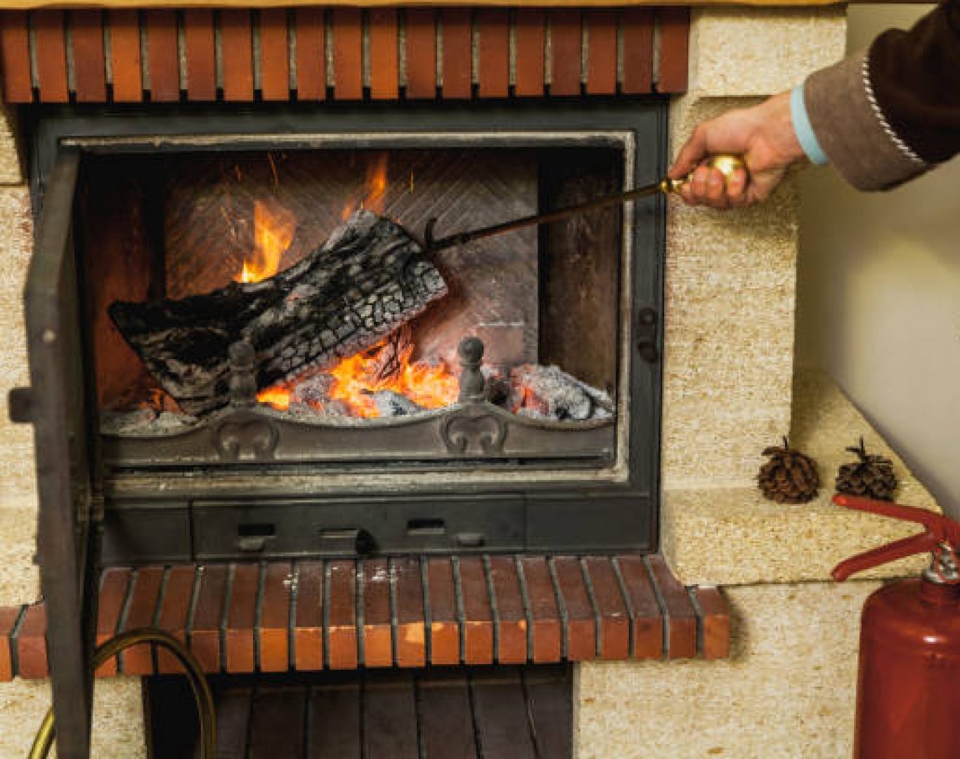Gas Fireplace Service in Newcastle, WA technician inspecting pilot assembly inside a modern fireplace
