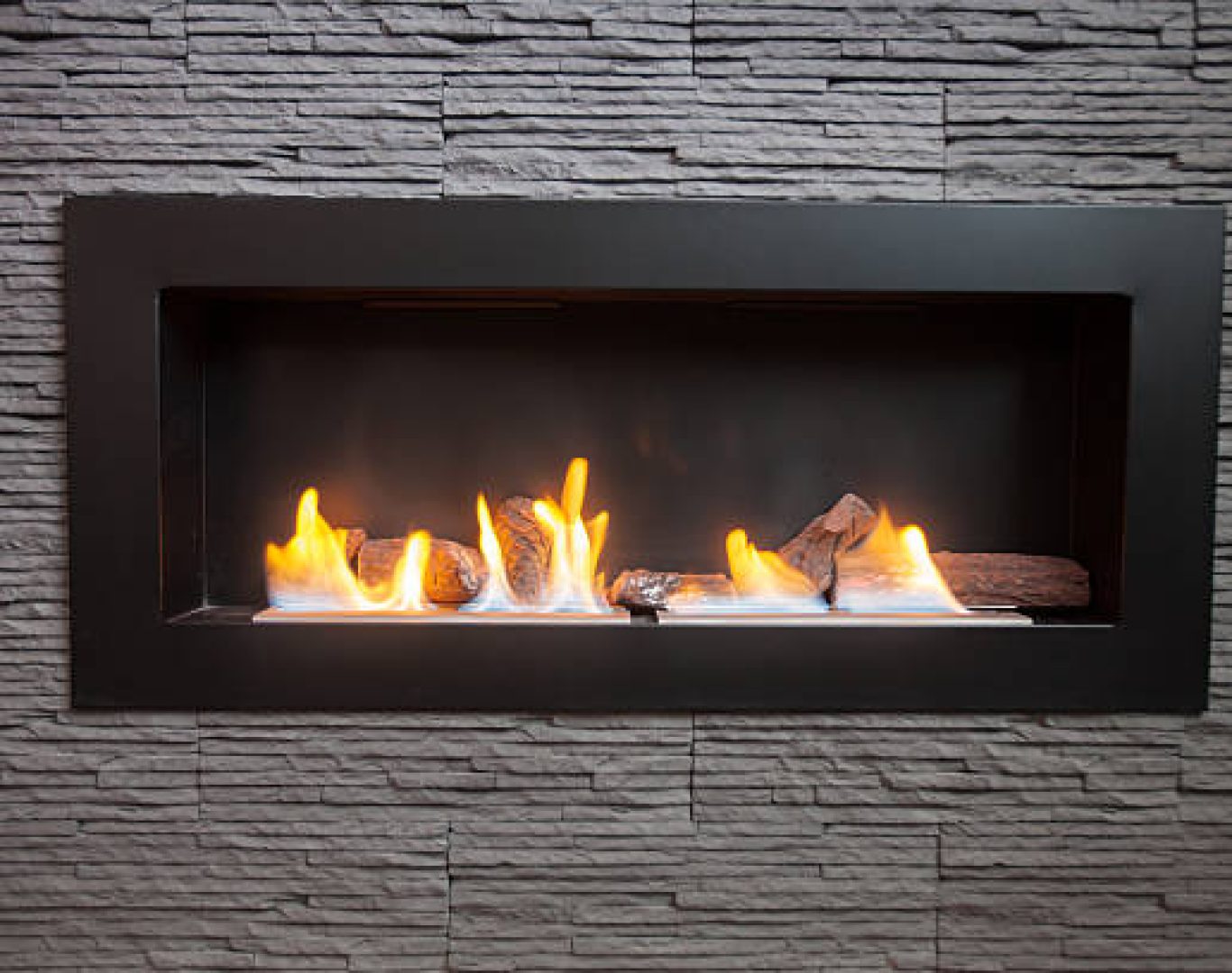Specialist performing Gas Fireplace Service near a hearth in Newcastle, WA while testing vent and flame pattern