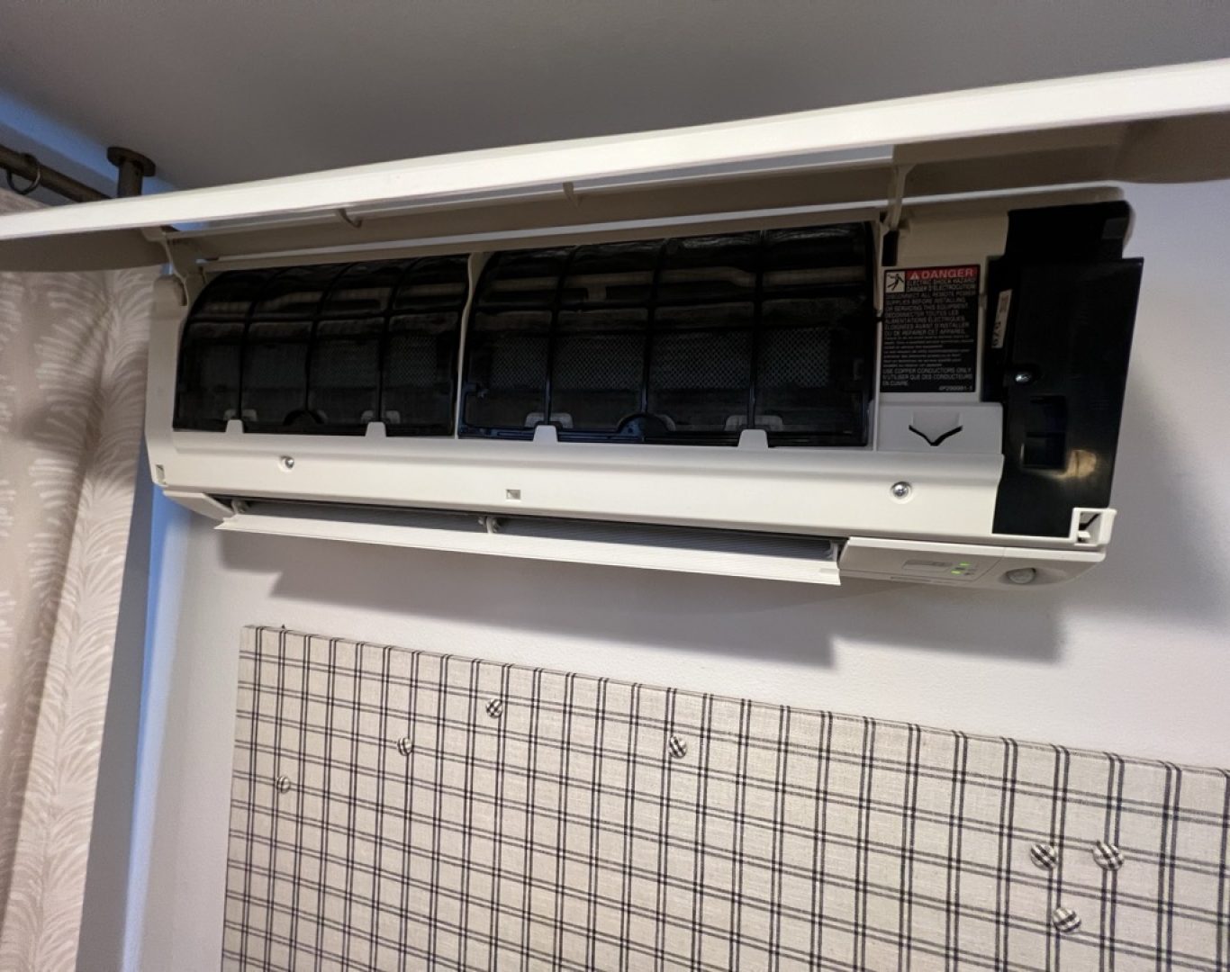 Technician using advanced tools to calibrate Daikin mini split system for precise climate control in Newcastle, WA property