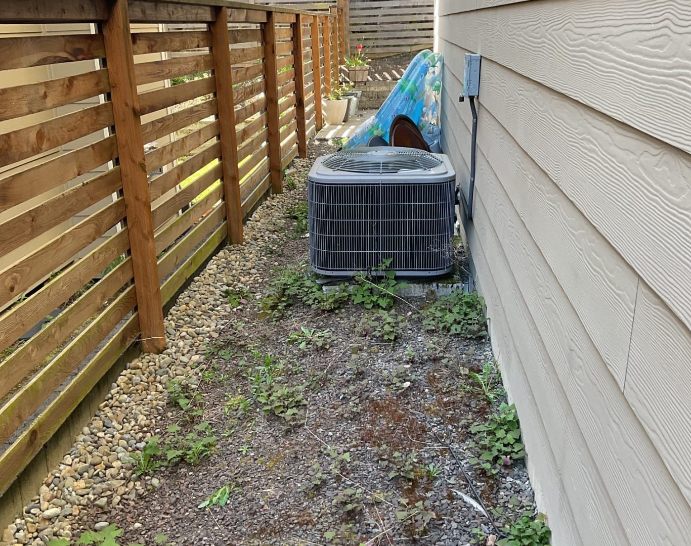Pelican Heating and Air technician servicing a residential air conditioning unit in Bellevue, WA