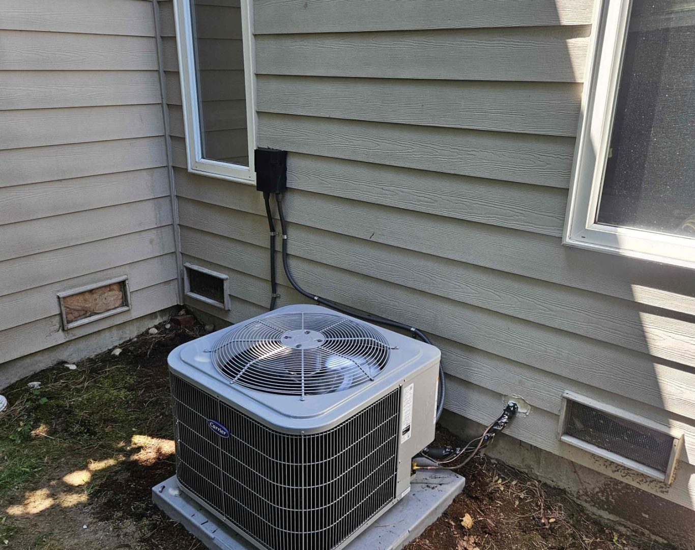 Pelican Heating and Air technician servicing a residential air conditioning unit in Bellevue, WA