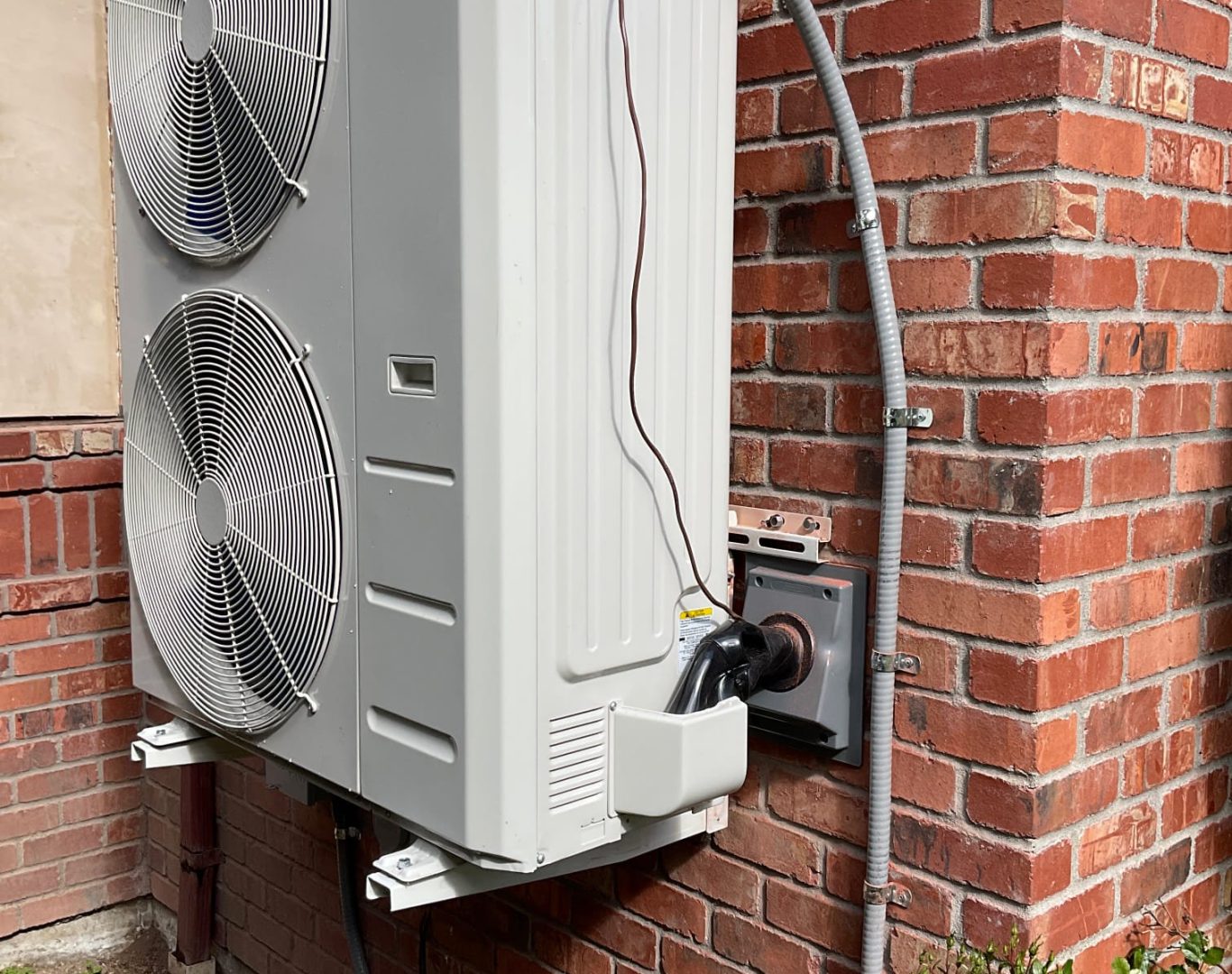 Pelican Heating and Air technician servicing a residential air conditioning unit in Bellevue, WA