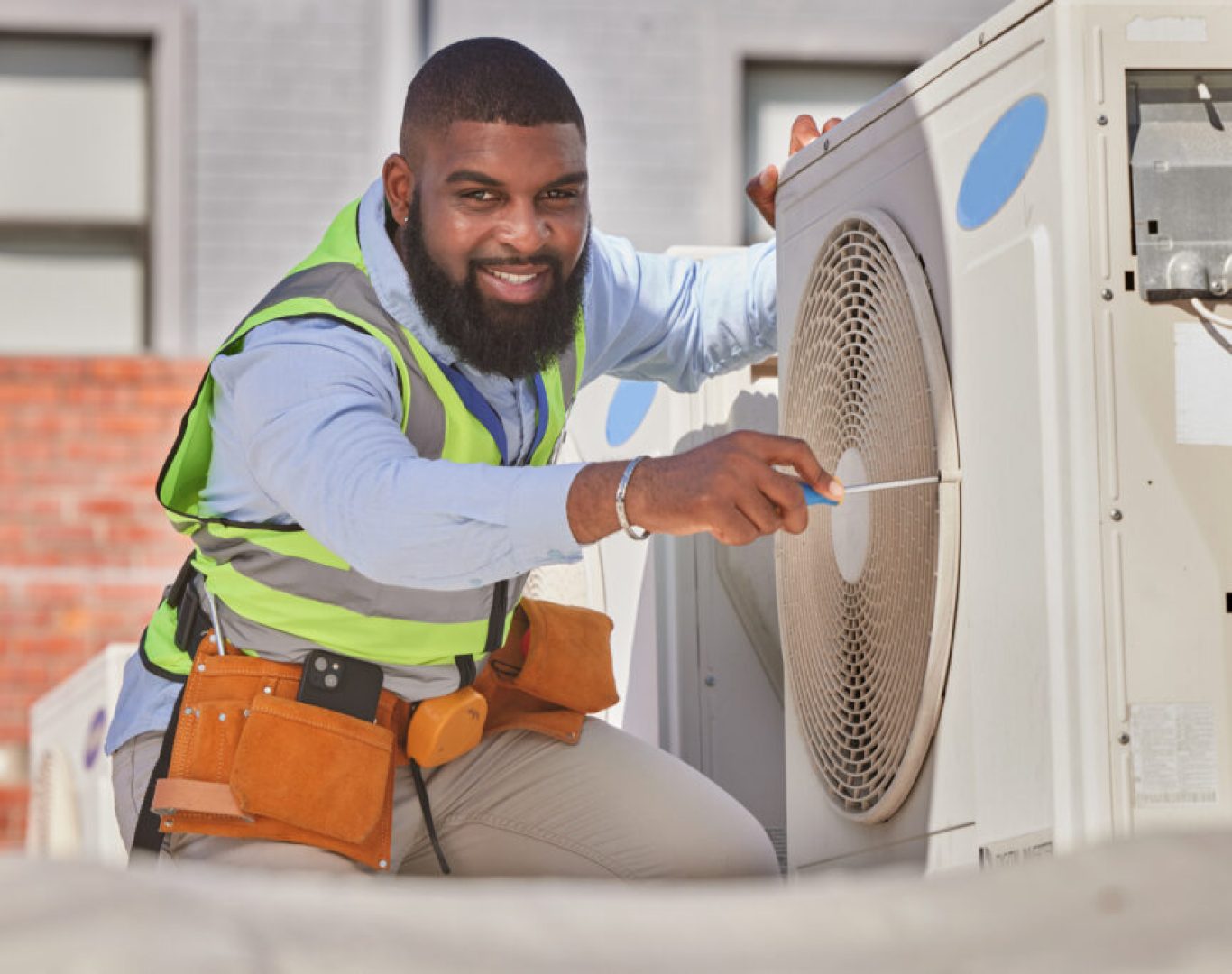 Pelican Heating and Air technician servicing a residential air conditioning unit in Bellevue, WA