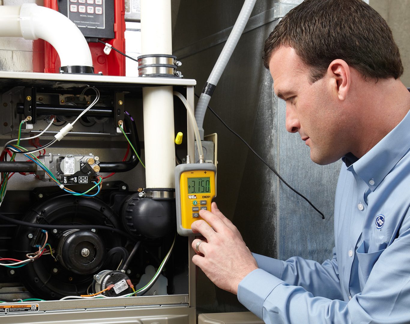 Pelican Heating and Air technician servicing a residential air conditioning unit in Bellevue, WA