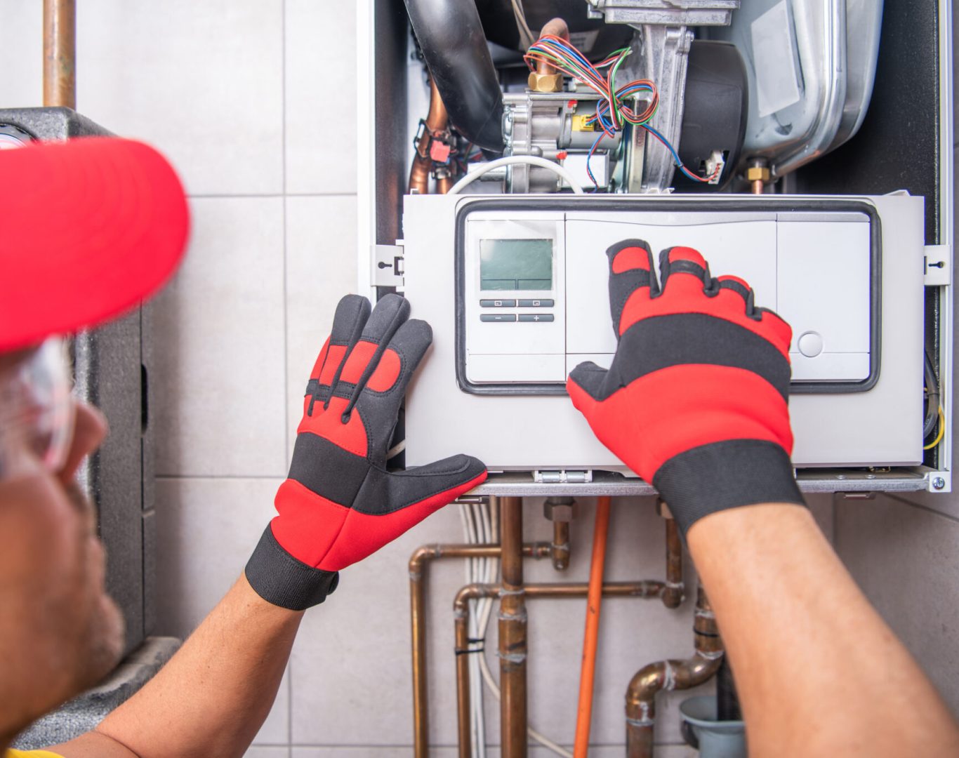 Pelican Heating and Air technician servicing a residential air conditioning unit in Bellevue, WA
