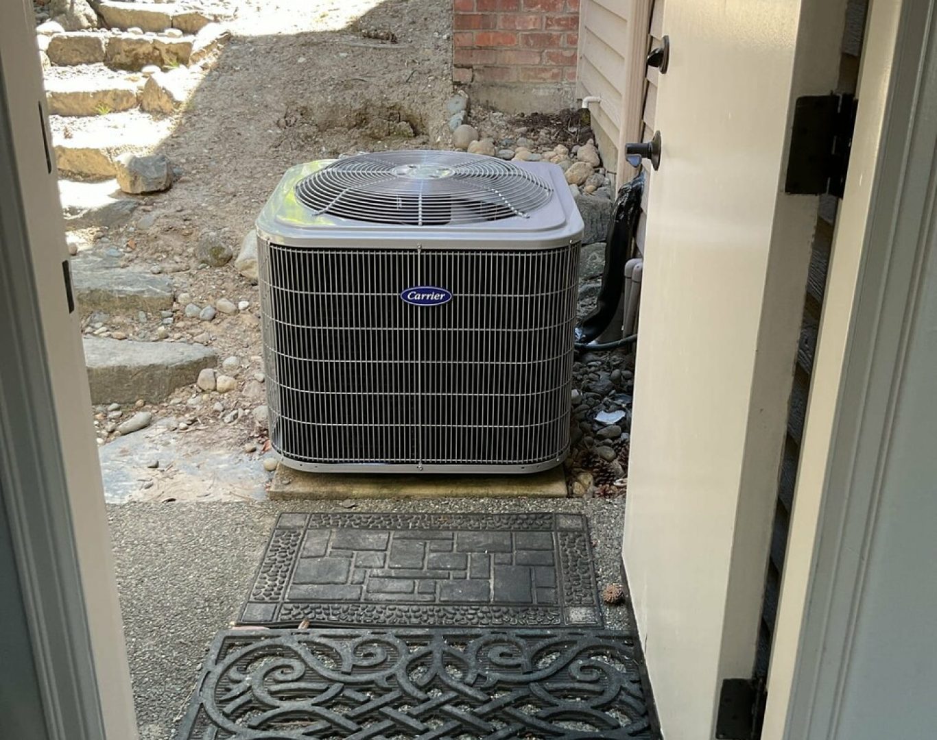 Pelican Heating and Air technician servicing a residential air conditioning unit in Bellevue, WA